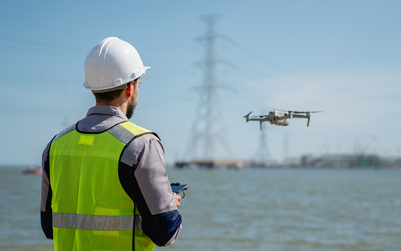 engineer-in-a-safety-vest-operating-a-drone